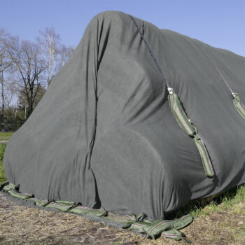 Close-up of a silage stack covered with protec Premium fleece 160 g, additionally secured with safeline and silage bags for protecting the silage